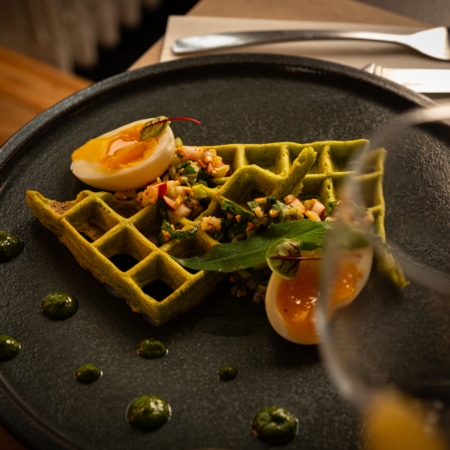 Waffles with wild garlic pesto, soft-boiled eggs & almond sauce vierge