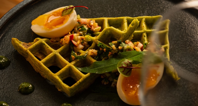 Waffles with wild garlic pesto, soft-boiled eggs & almond sauce vierge